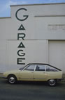 Citron GS Pallas poses before an art dco garage facade. (46kb)